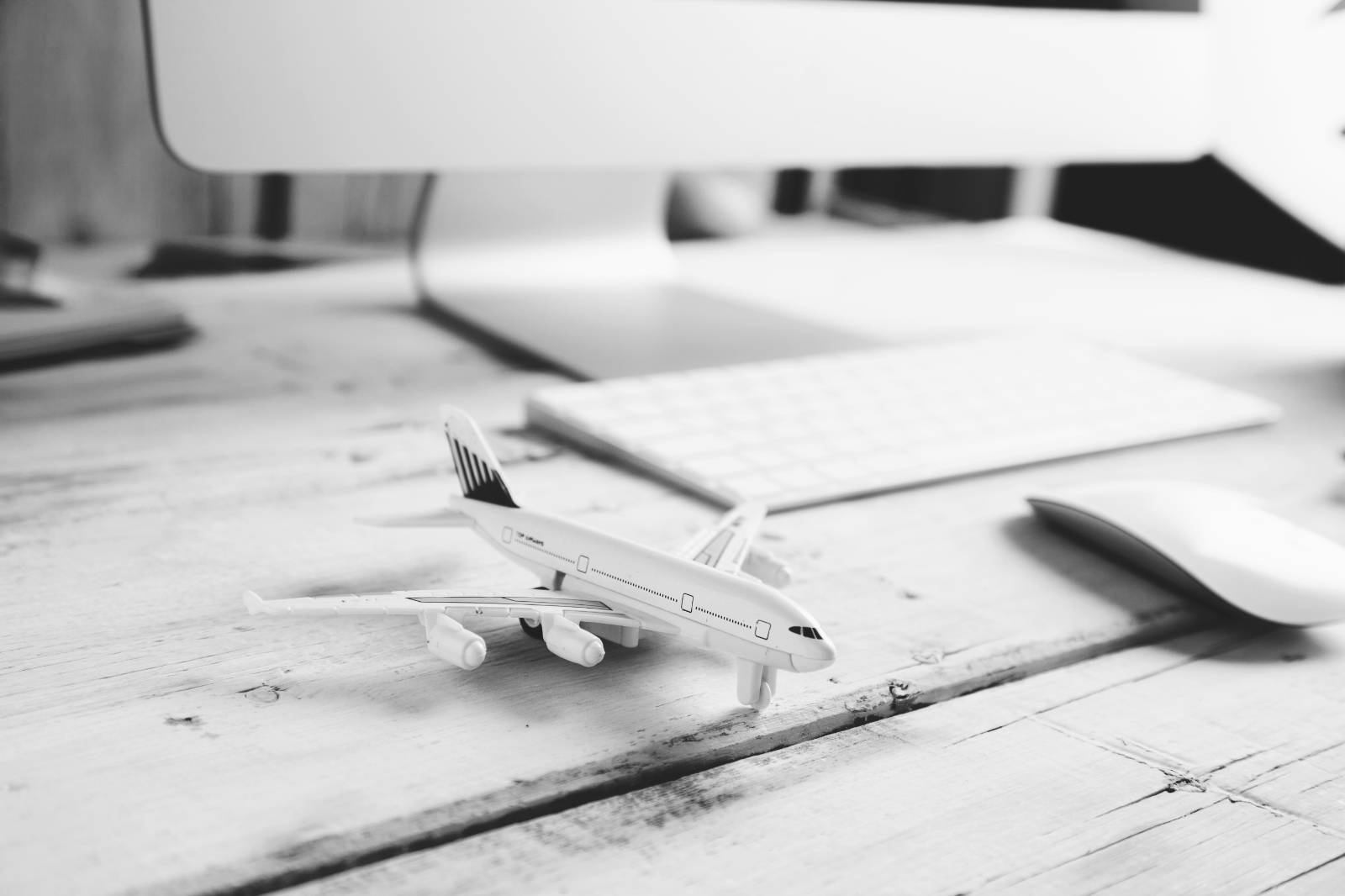A model aircraft on a desk next to a computer keyboard